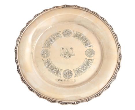 An Irish silver salver, engraved with the arms of County Cork in Celtic style border and applied rim, on three claw and ball 