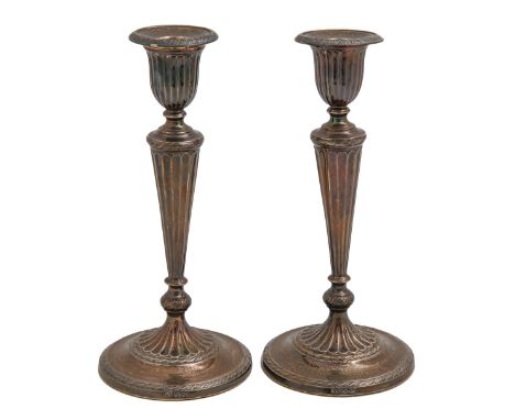 A pair of George V silver candlesticks, in neo classical style, nozzles, 23cm h, by Elkington &amp; Co Ltd, Sheffield 1912, l