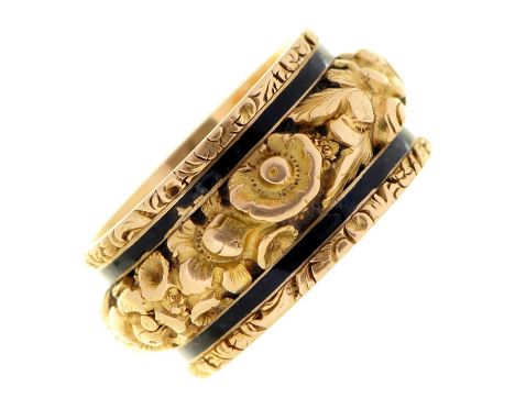 An 18ct gold and black enamel mourning ring, with concealed compartment, the band chased in high relief with flowers between 