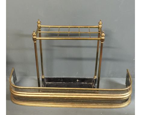 A GEORGIAN DESIGN BRASS STICK STAND With a twelve section division, along with a pierced brass fire curb.