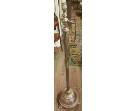 AN EARLY 20TH CENTURY BRASS TELESCOPIC STANDARD LAMP With fluted column and honeycomb base.