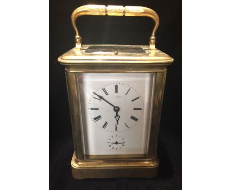 ROLLIN, PARIS, A VICTORIAN GILDED BRASS REPEATING CARRIAGE CLOCK The engraved gilded brass case having four bevelled glass pa