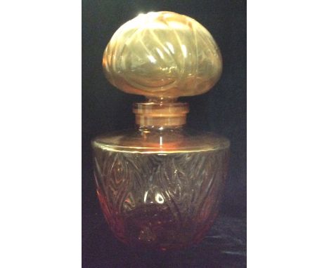 FABERGÉ, A LARGE 20TH CENTURY AMBER GLASS SHOP DISPLAY PERFUME BOTTLE AND STOPPER Moulded with stylized leaf decoration and m