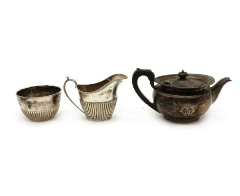 A composed silver three piece tea service,comprising a teapot, by Elkington &amp; Co Ltd, Birmingham 1922, 22cm wide, a cream