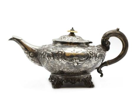 A Victorian silver teapot,possibly by Benjamin Reece Dexter, London 1842, the hinged lid with an ivory finial above a repouss