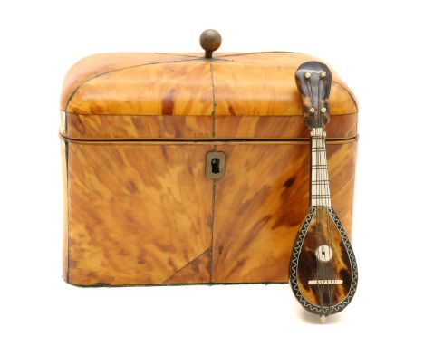 A blond tortoiseshell tea caddy,early 19th century, of rounded rectangular form, with six segmented lid, the fitted interior,