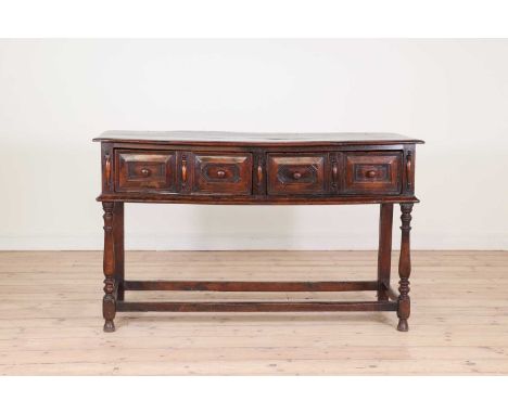 An oak dresser base,late 17th century and later, the two long drawers with mitred fronts, raised on turned baluster supports 