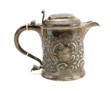 A Queen Anne Britannia silver tankard,date and maker's mark indistinct, with ivory insulators, later embossed with floral dec