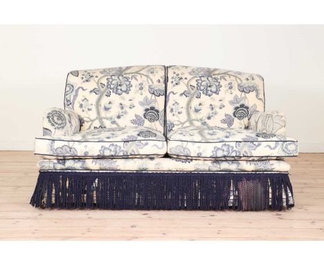 A two-seater sofa in the manner of Howard & Sons, third quarter of the 20th century, upholstered in foliate calico with a dar