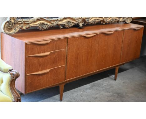 A Scottish McIntosh Dunvegan mid-century teak sideboard designed by Tom Robertson circa 1960, with central shelved cupboards,