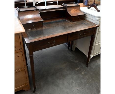 An Edwardian Carlton house style mahogany desk with tooled leather top and two frieze drawers, square supports and casters, 9