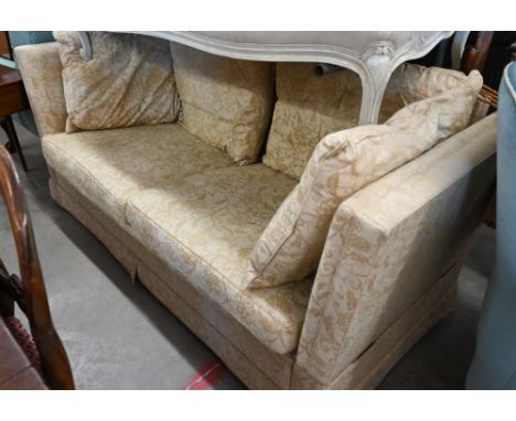 A Knole two-seater sofa with old gold floral upholstery and turned hardwood finials, 192 x 90 x 100 cm high