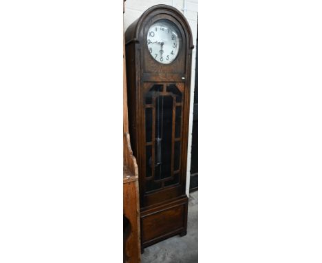 A 1930's Art Deco arched oak longcase clock with glazed door, silvered dial with Arabic numerals on triple train movement, c/