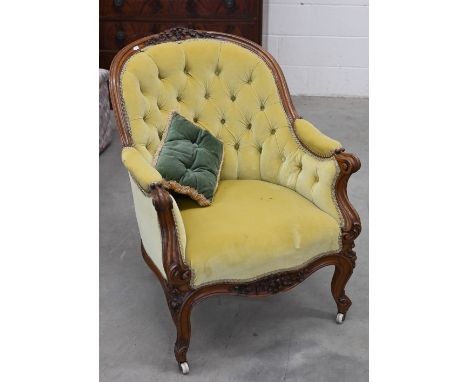 A 19th century French armchair with floral carved walnut frame upholstered in button back yellow fabric, 70 cm w x 80 cm d x 