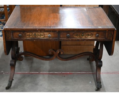 A Regency crossbanded rosewood and brass inlaid sofa table with two drawers and opposing dummy drawers raised on twin lyre su