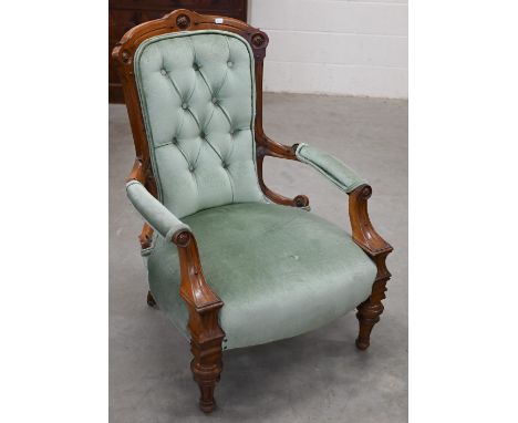 A late Victorian walnut framed open armchair upholstered in pale teal button back fabric Brass casters on back legs only 