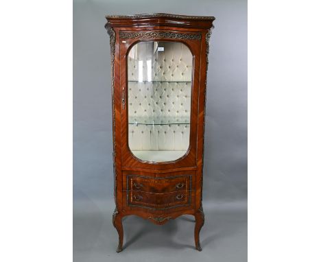 A continental brass mounted kingwood serpentine form salon display cabinet, the interior with button backed lining and glass 