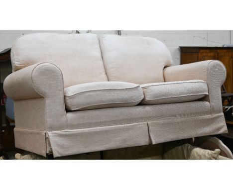A modern scroll-arm two-seater sofa upholstered in woven buttermilk fabric, 178 cm w x 90 cm h x 100 cm h&nbsp; Signs of wear