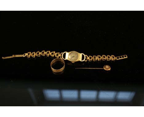 An 18ct gold ladies watch on plated strap, a 9ct gold pierced band ring plus a 15ct gold stick pin set with a small diamond