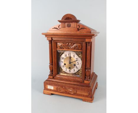An oak cased oversized mantle clock with brass and silvered dial