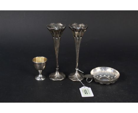 A silver egg cup with presentation inscription, a white metal wine taster and a pair of twisted design silver bud vases