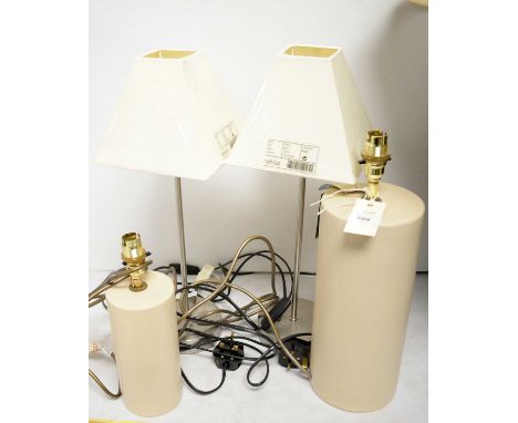 Two cylindrical ceramic table lamps, with brass fittings, 39cms and 28cms high respectively; together with another pair of ta