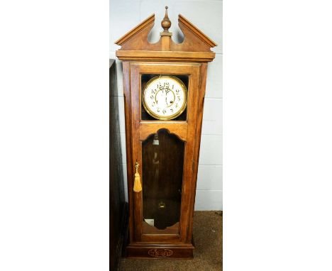 A German walnut-cased wall clock circa 1900, the enamelled Arabic dial with movement stamped 'DRGM', bi-metallic pendulum, in