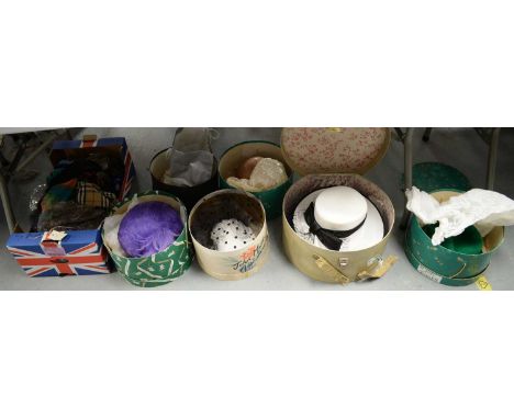 A selection of lady's vintage dress hats, including: green bowler hat; a purple feathered hat; a black and white polka dot ha