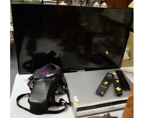 A Hisense LED back-light TV, 32in., on stand; together with a Panasonic DVD recorder; and a Canon EOS500 camera, in Optex cam