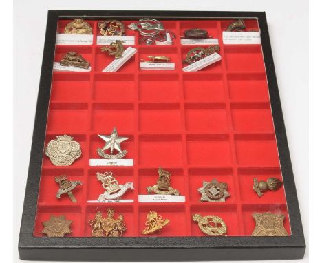A collection of military cap badges, including; WWI Royal Tank Corp; WWII pattern Royal Armoured Corps; WWII Royal Armoured C