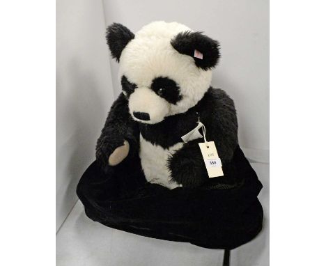 A Steiff giant panda teddy bear, no.45 Alpaca, with label, button and tag to ear, approximately 46cms high (seated).