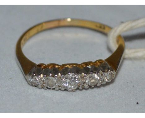 A diamond ring, four diamonds weighing a total of approximately 0.25carats, one stone a replacement white stone, on yellow me