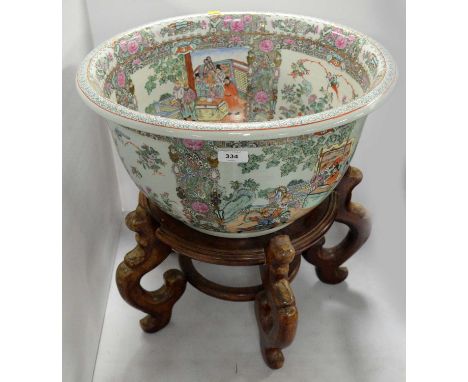 An early 20th Century Chinese Famille Rose bowl or planter, the interior and exterior decorated with alternating panels of fi