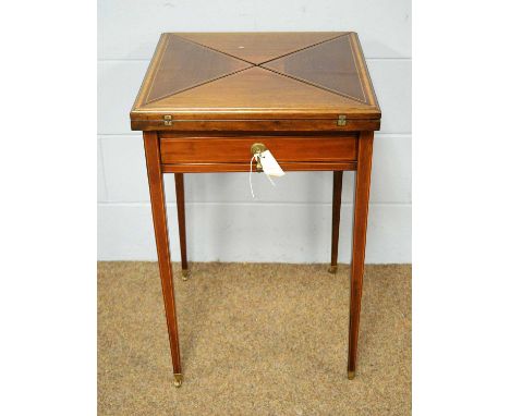 An Edwardian mahogany and satinwood banded envelope card table, with swivel top opening to reveal a baize-lined interior with