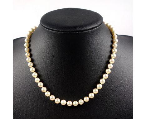 Cultured pearl necklace, cream pearls, 6mm approx. in diameter, strung with knots, 14 ct white gold clasp set five small diam