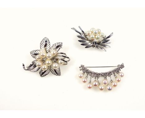 White metal and pearl floral brooch, W.5.6cm, stamped "silver"; crescent pearl brooch, stamped "950 SV", and a Chinese floral