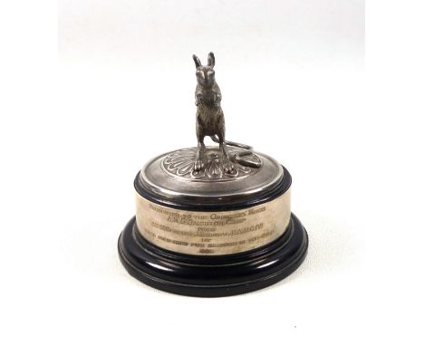 Silver model of a desert rat, mounted on an ebonised socle base, with silver presentation band inscribed “Presented to the Of