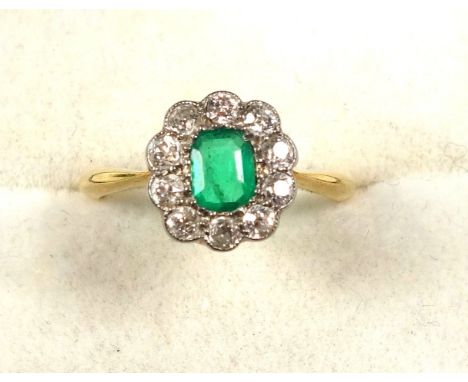 Yellow metal daisy cluster ring, stamped 18, ring size M, set emerald cut emerald surrounded by 10 old cut diamonds, 2.6 gram