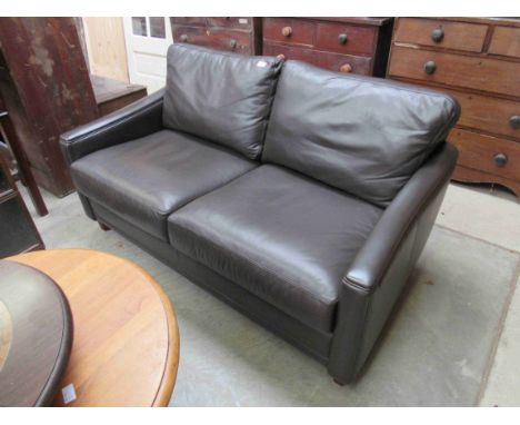 A brown leather two seater sofa 