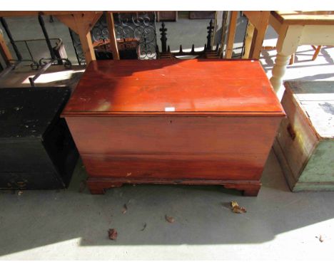 A stained pine blanket box on bracket feet 