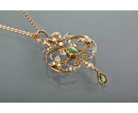 EDWARDIAN PERIDOT AND SEED PEARL HOLBEIN
of sinuous openwork form, in a seed pearl setting with an oval peridot and with a pe