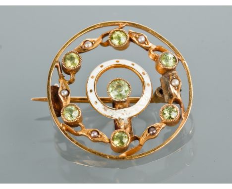 EDWARDIAN PERIDOT AND ENAMEL BROOCH
of circular openwork form, set with round peridots seed pearls and with a central circula