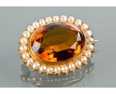 EARLY TWENTIETH CENTURY CITRINE AND PEARL BROOCH
the oval citrine surrounded by split pearls, marked 15ct to the reverse, 26m