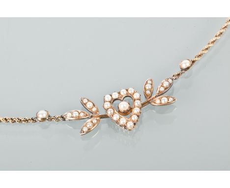 EDWARDIAN FIFTEEN CARAT GOLD PEARL SET NECKLET
formed by a pearl set heart motif flanked by foliate motifs, on a rope twist c
