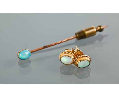 OPAL STICK PIN
set with an oval opal with good colour and fire, unmarked; along with a pair of similar opal stud earrings (2)