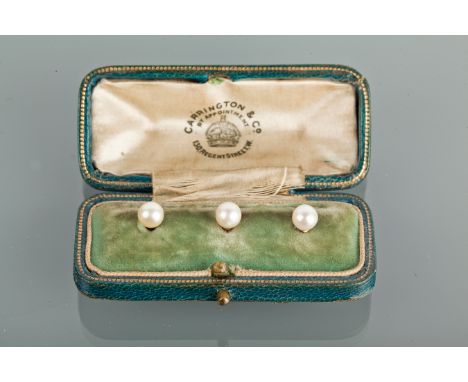 SET OF THREE EARLY TWENTIETH CENTURY PEARL SHIRT STUDS
each set with a spherical white pearl, marked 9ct, in a fitted case