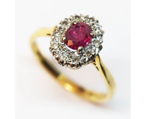 A ruby and diamond cluster ring, hallmarked 18ct gold band, gross weight3.6g, size O/P.  