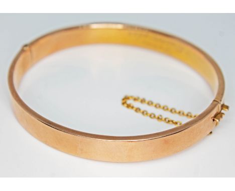 A hallmarked 9ct gold bangle, wt. 9.9g.Condition: minor surface wear only, no signs of any damage or repairs, no dents, hinge