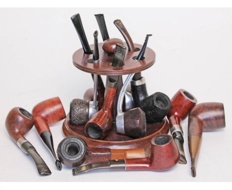 A Dunhill mahogany pipe rack and 12 vintage pipes.  