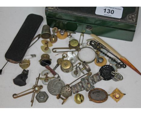 An old trinket box containing cuff links, badges, brooches etc.  